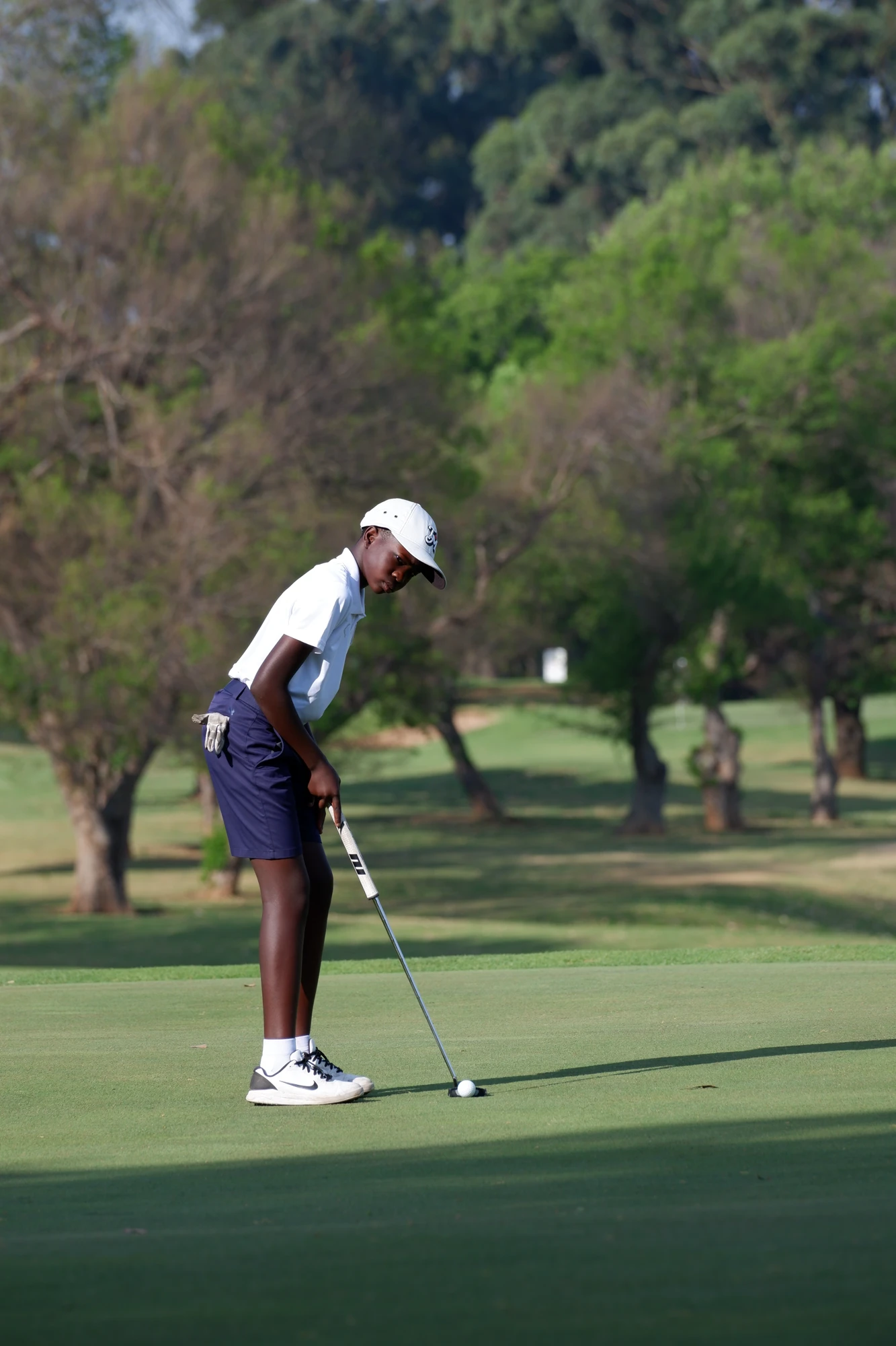 Esca Young Golfer Preparing To Putt