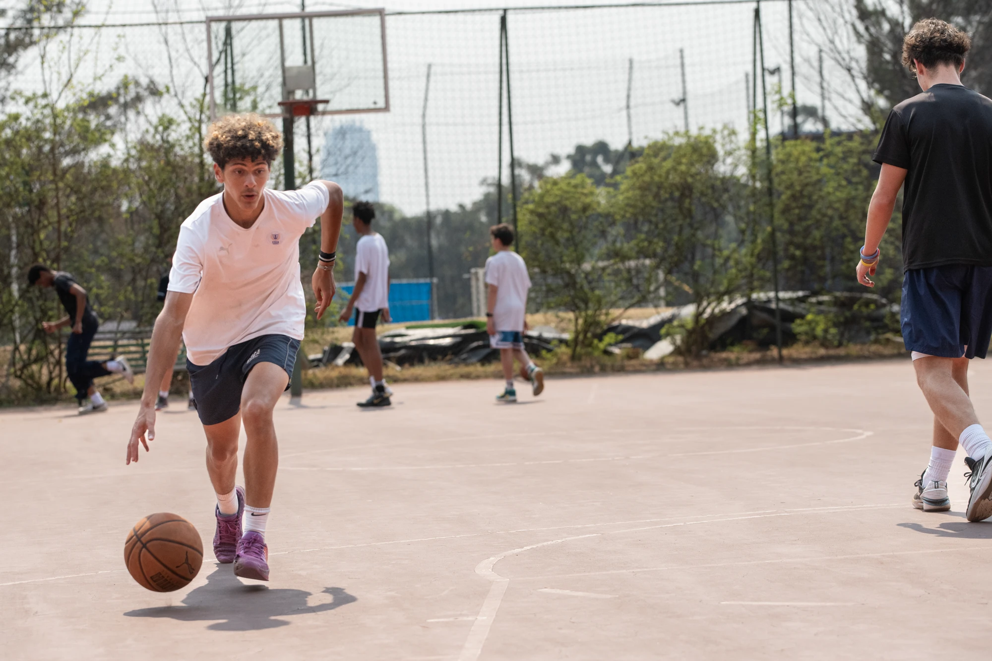 Esca Young Person Dribbling Basketball