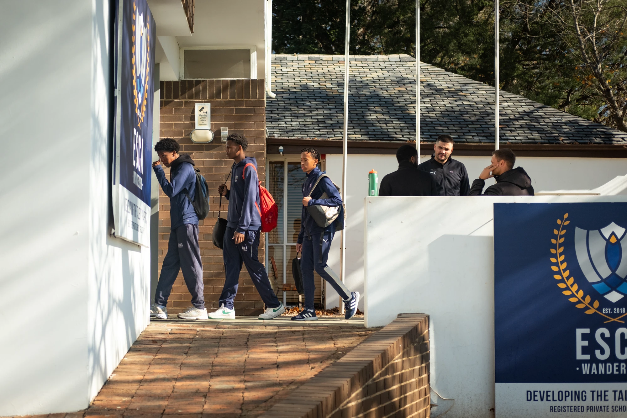 Esca Students Walking Outside School Building
