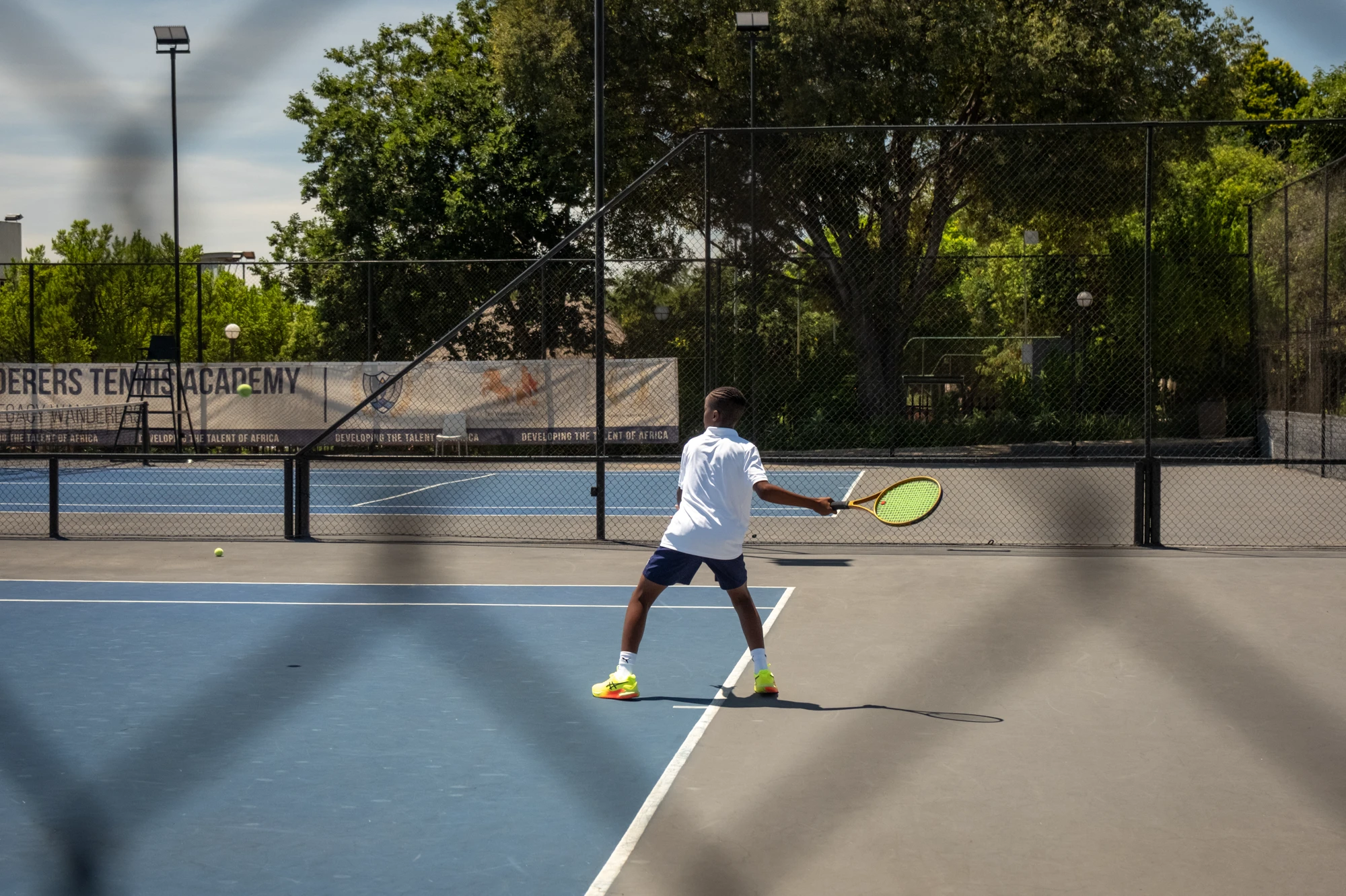 Esca Child Playing Tennis On Court