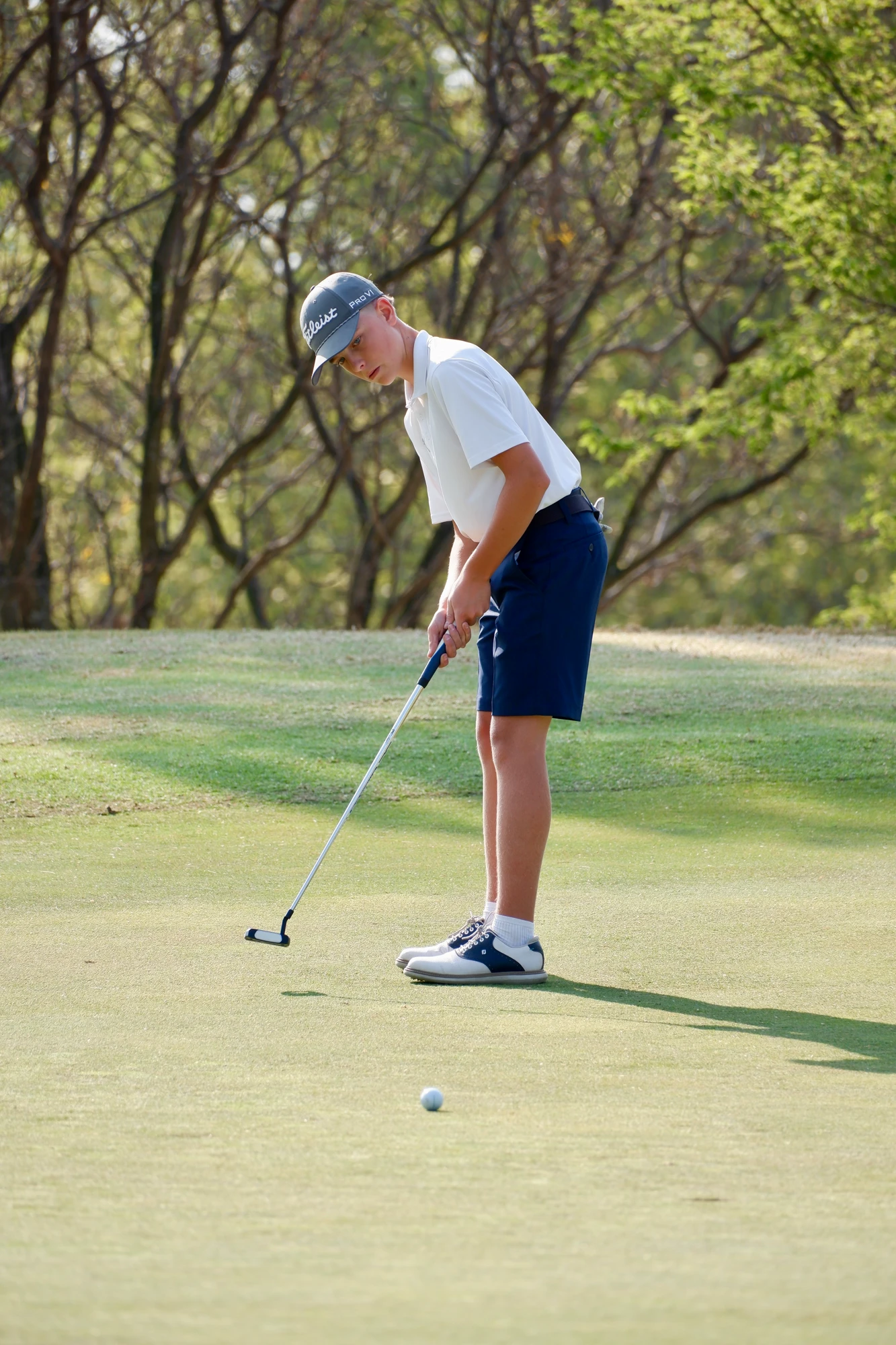 Esca Boy Putting On Golf Course