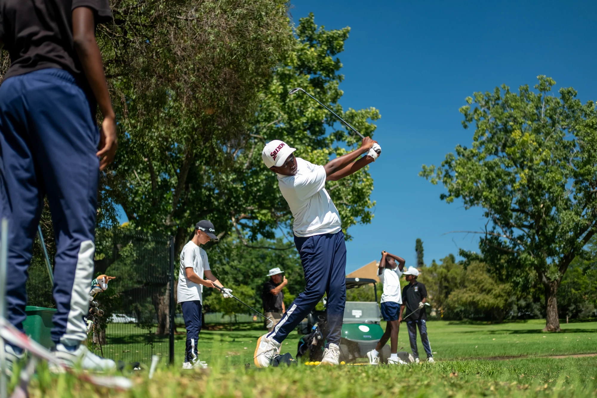 Esca Young Golfer Swinging Club