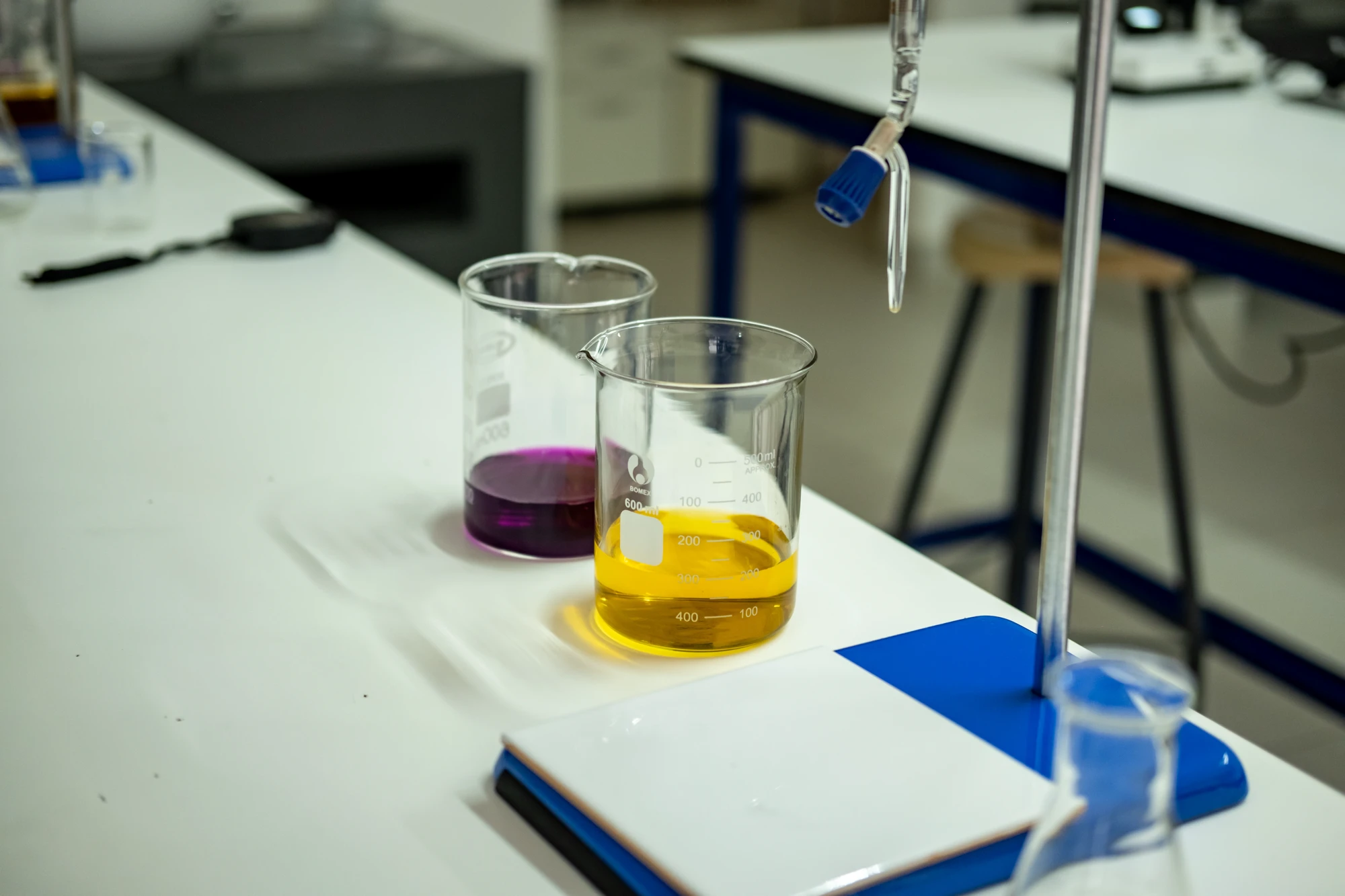 Esca Beakers With Colorful Liquids On Table
