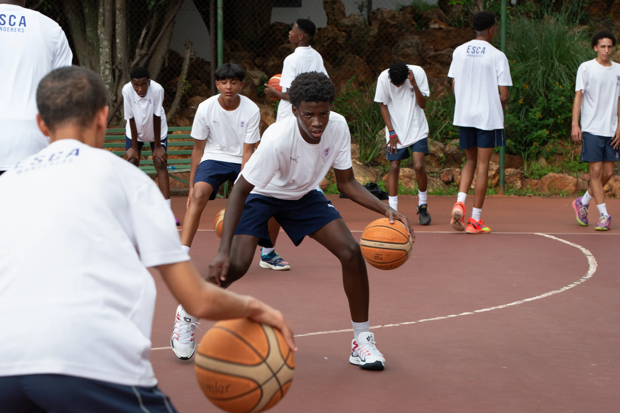 Esca Young Basketball Players Practicing Drills
