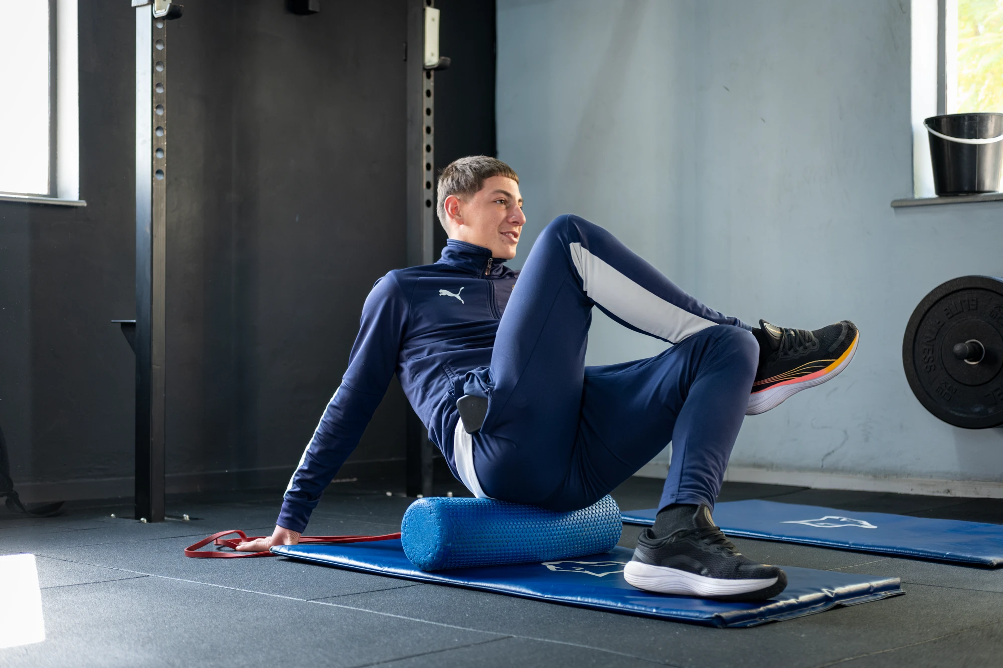 Esca Man Exercising With Foam Roller