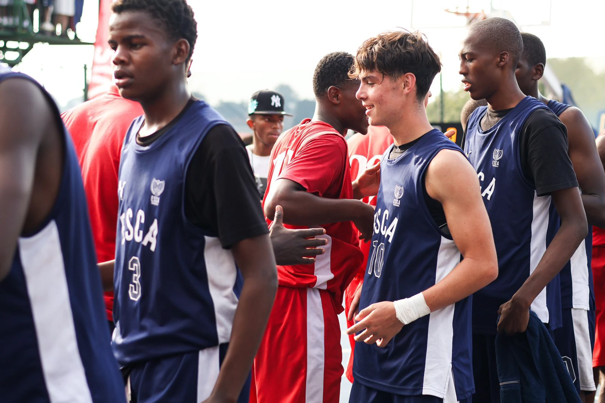 Esca Young Athletes On Field Talking Wearing Jerseys