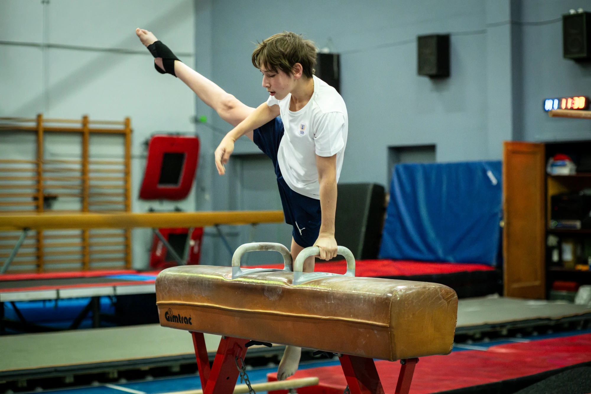Esca Young Gymnast Practicing On Pommel Horse