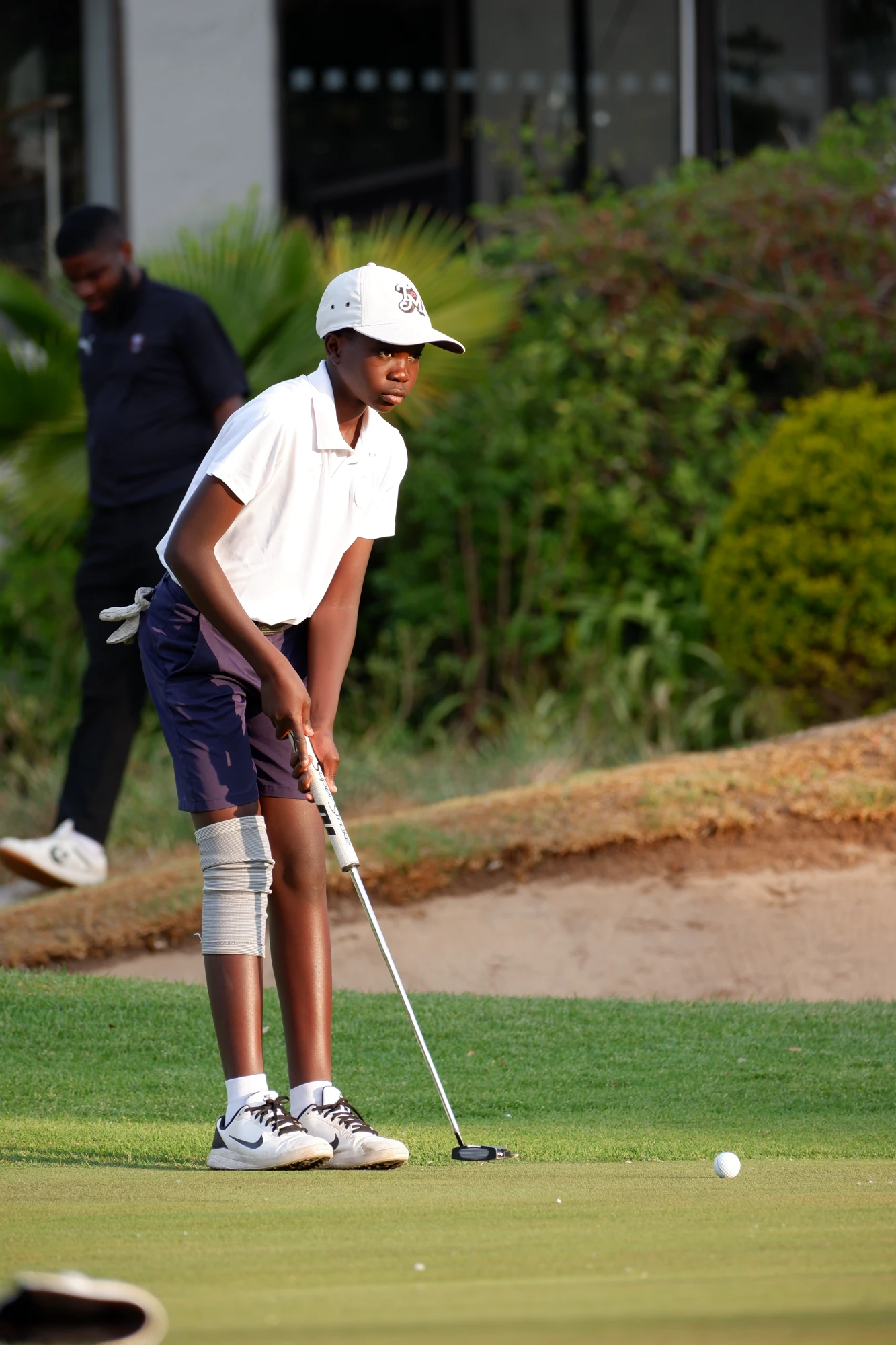 Esca Child Practicing Golf Putting