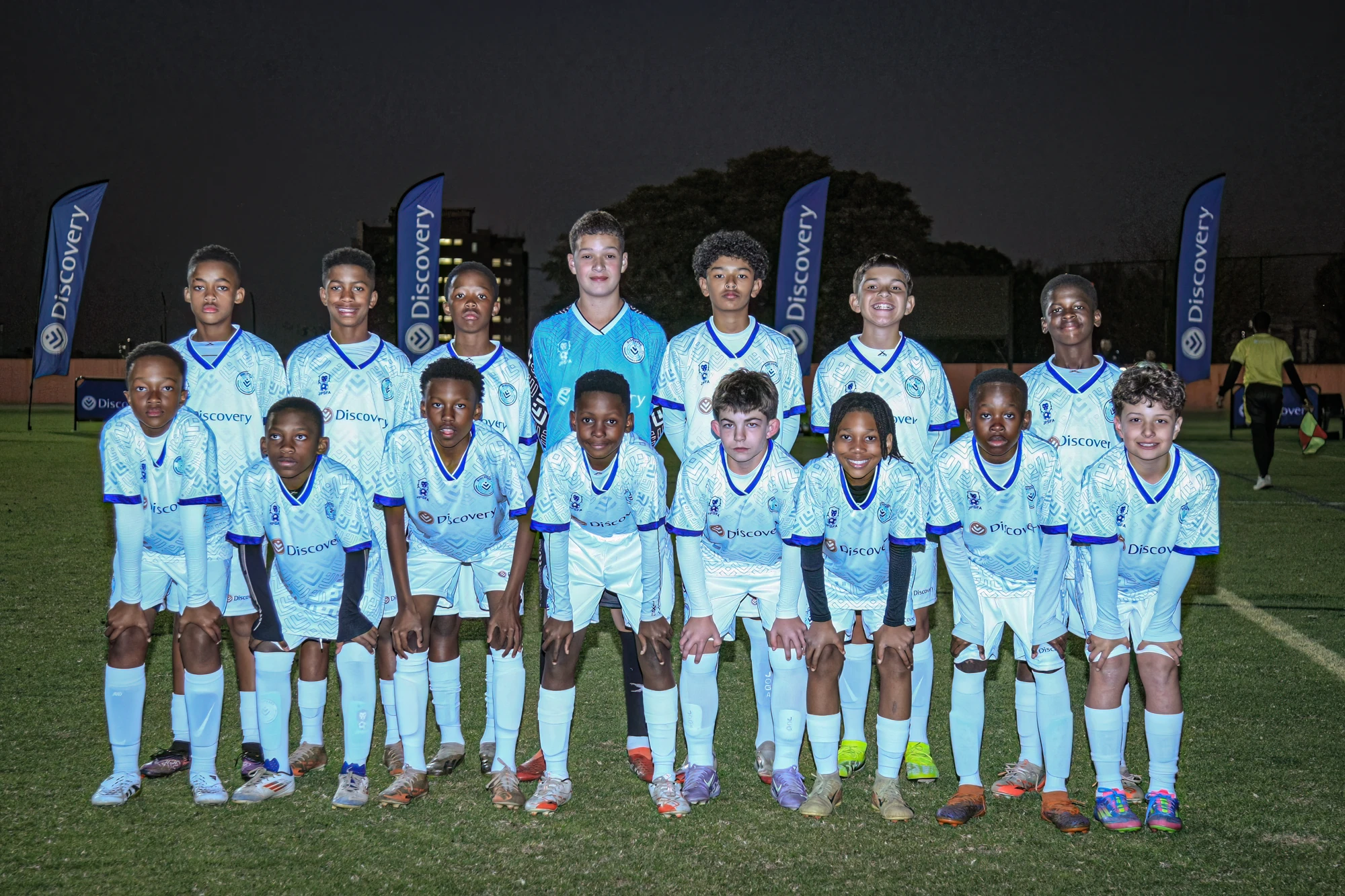 Esca Youth Soccer Team On Field At Night