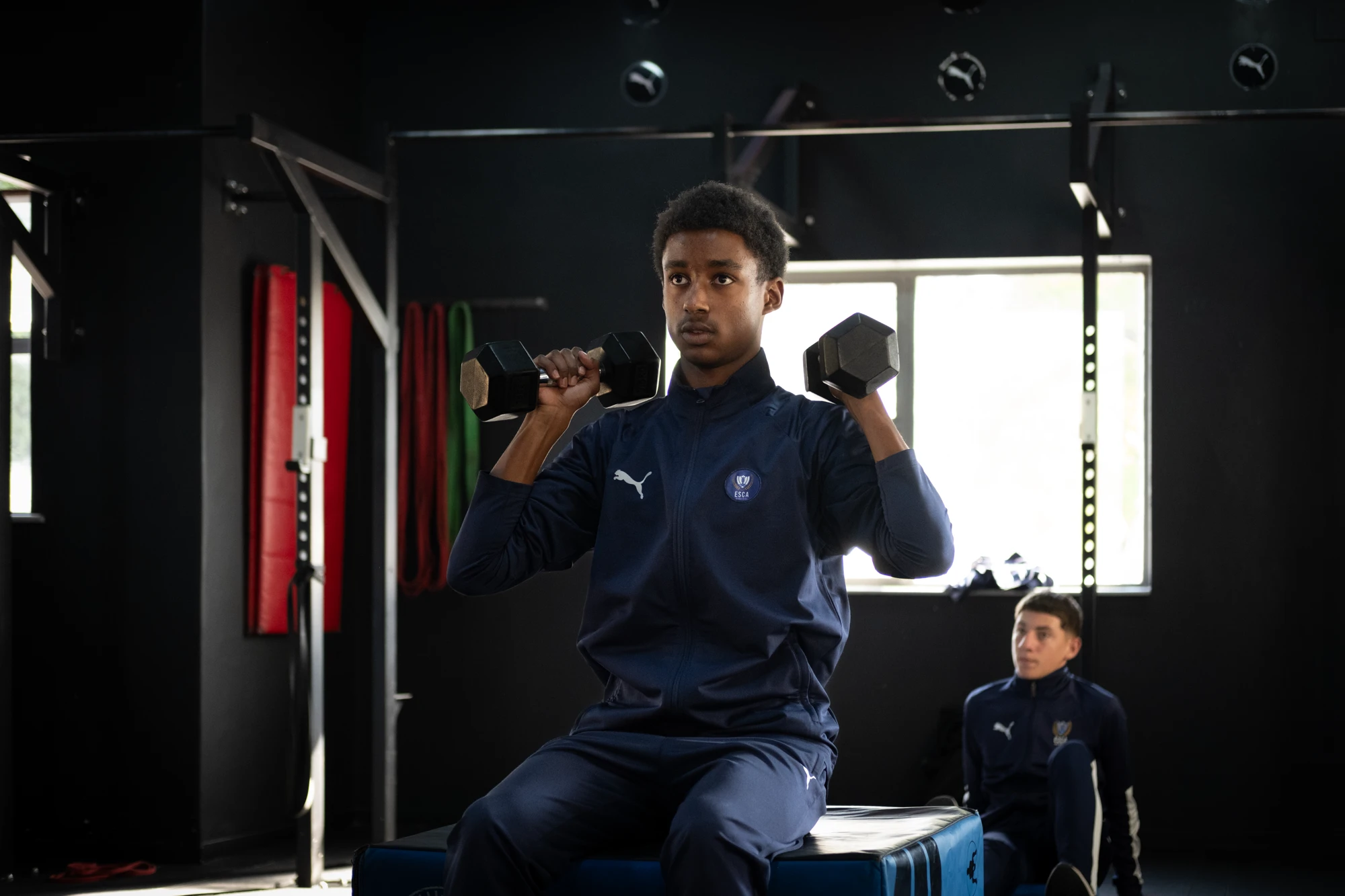 Esca Young Man Exercising With Dumbbells