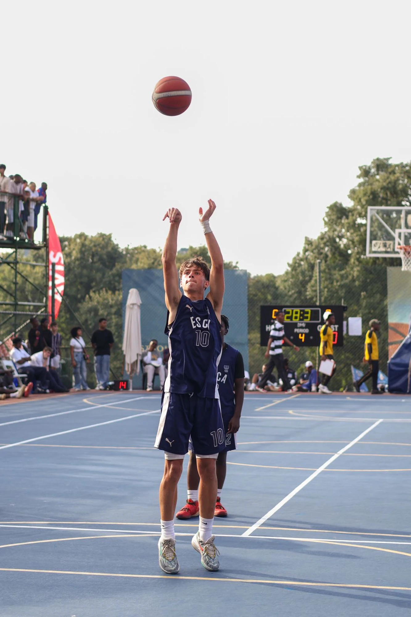 Esca Boy Shooting Basketball On Court