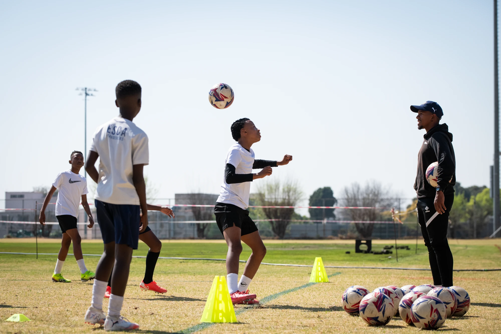 Esca Kids Practicing Soccer Drills Outdoors