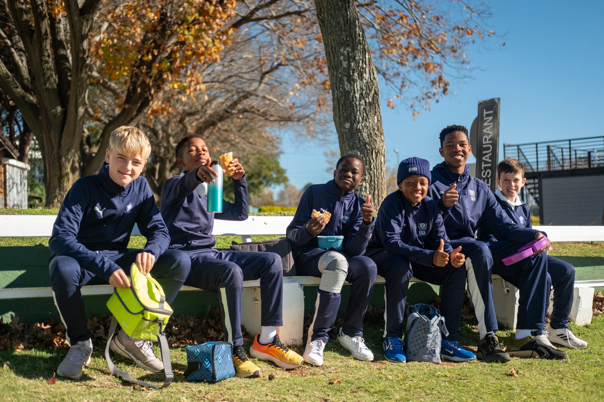 Esca Group Of Children Sitting Outdoors