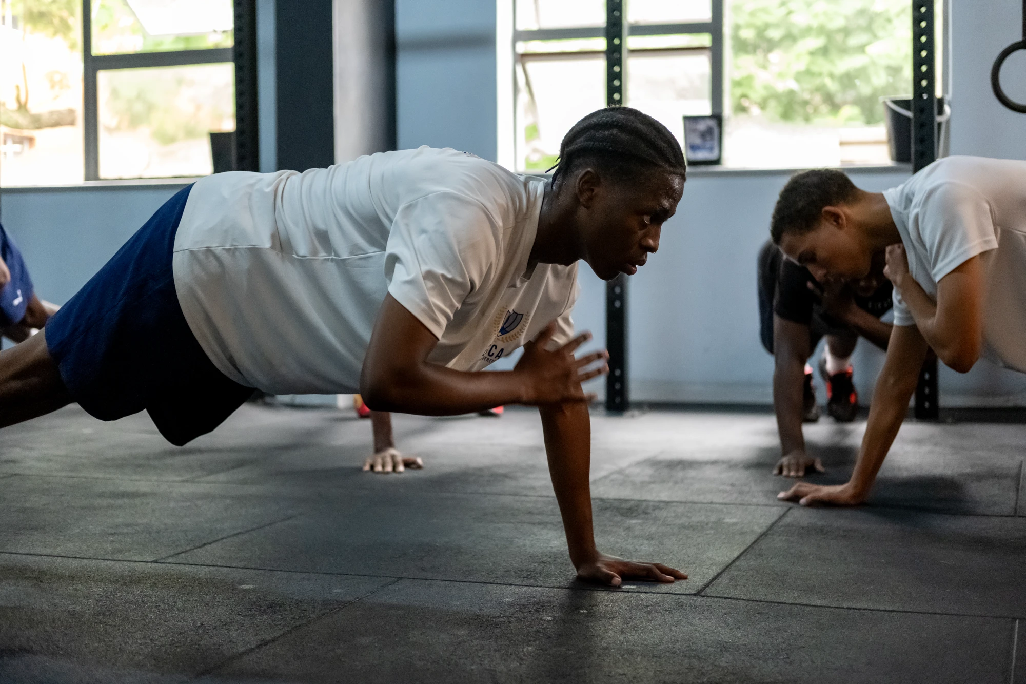 Esca People Doing Push Ups In Gym