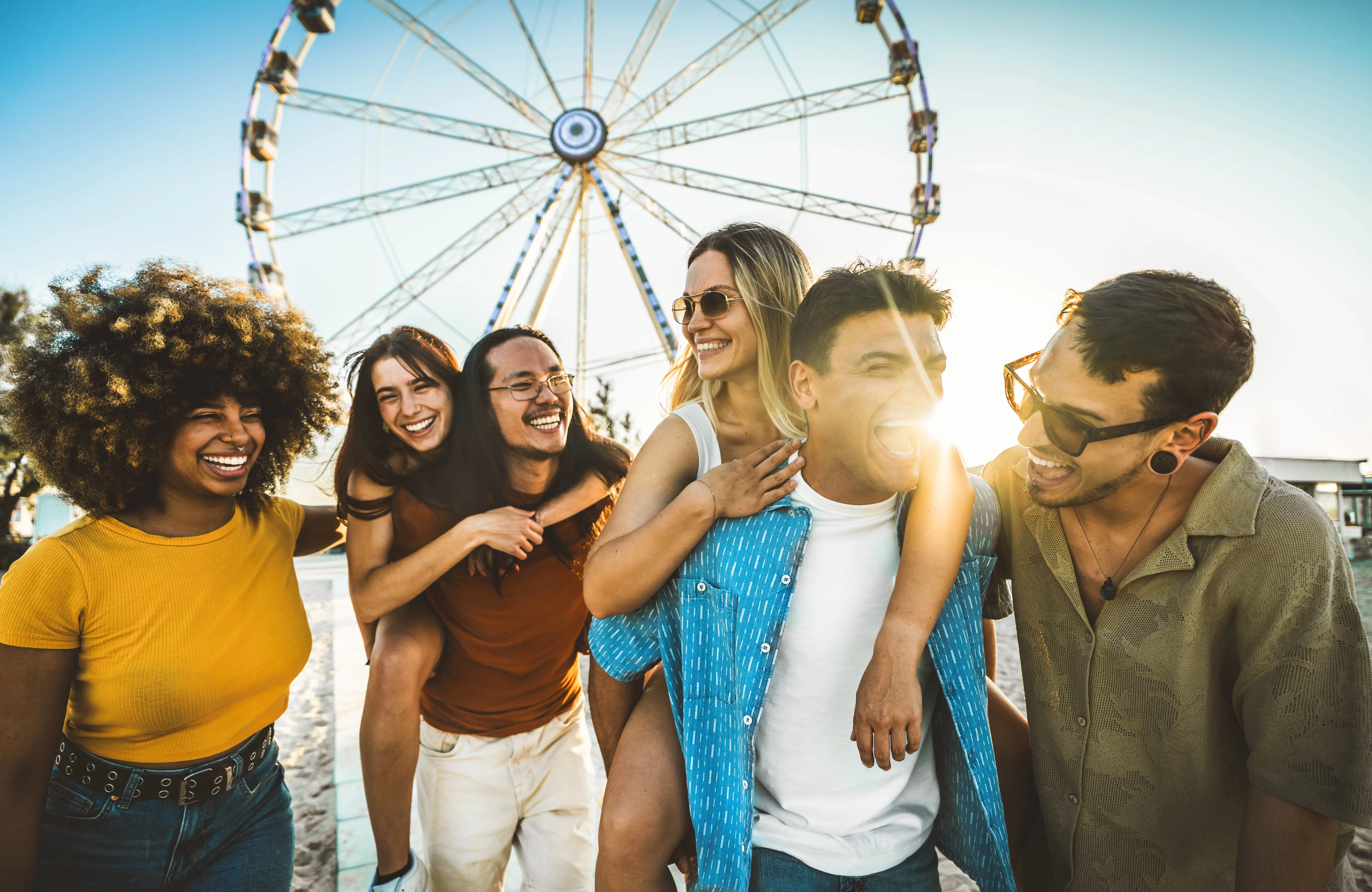 Friends at amusement park smiling stock image