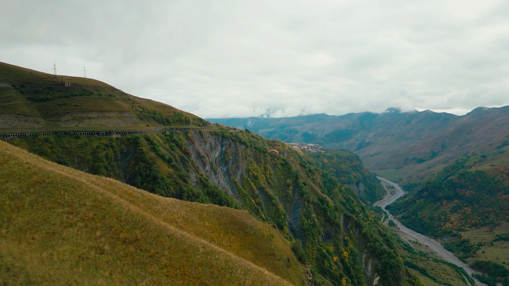 Paraglider above a valley in the Caucasus