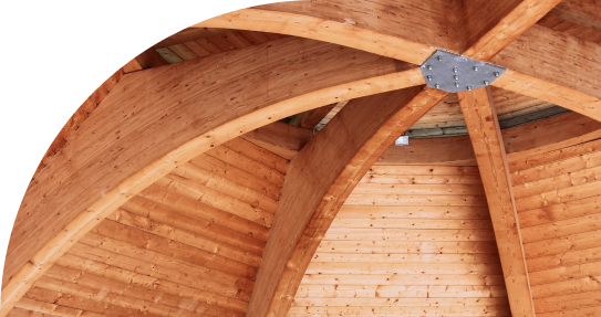 The wooden architecture of a building's interior with a wood-paneled ceiling with wooden beams.