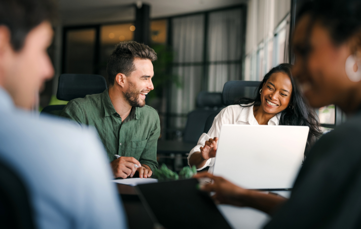 happy people working at large desk