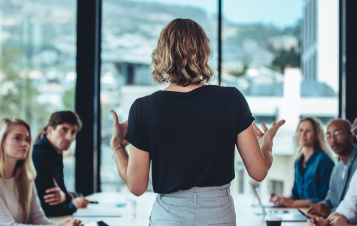 woman speaking to small team