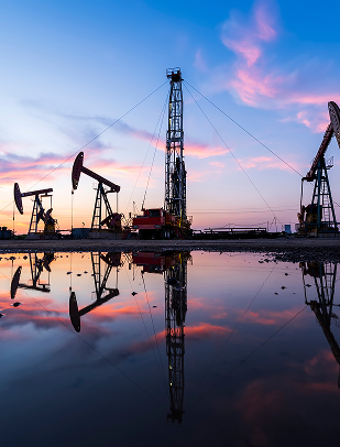Oil pumpjacks silhouetted at sunset
