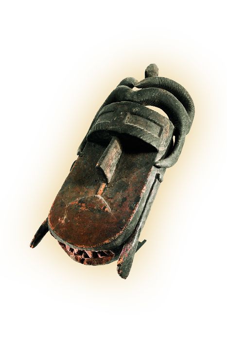 Carved wooden tribal mask with exaggerated facial features and curved horn-like decorations on top.