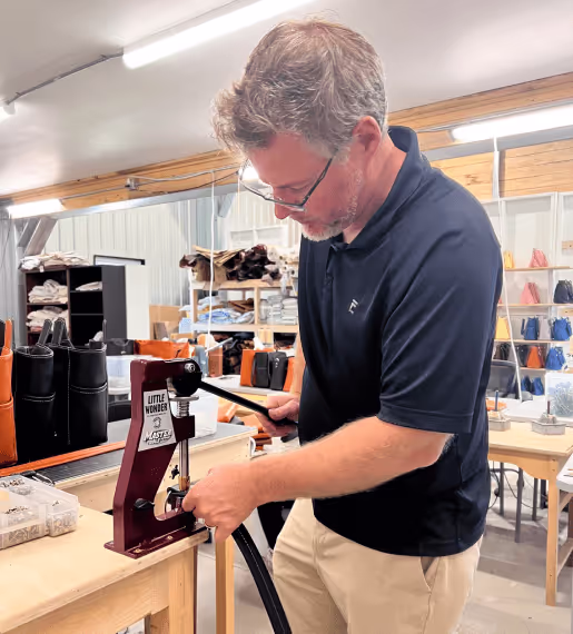 co-owner jerry fox working in leather shop at janell
