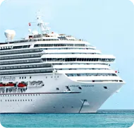 A cruise ship in the ocean with a blue sky in the background.