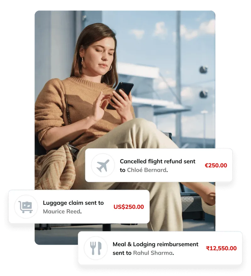 A woman sitting on a bench looking at her cell phone.