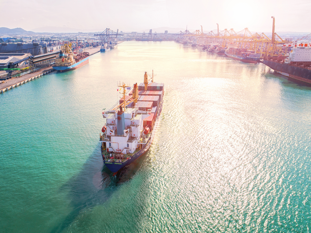 A ship enters a boat harbor. Inchange Shipping Services (ISS) uses Brightwell's payroll solution, Navigator, to pay its global workforce.