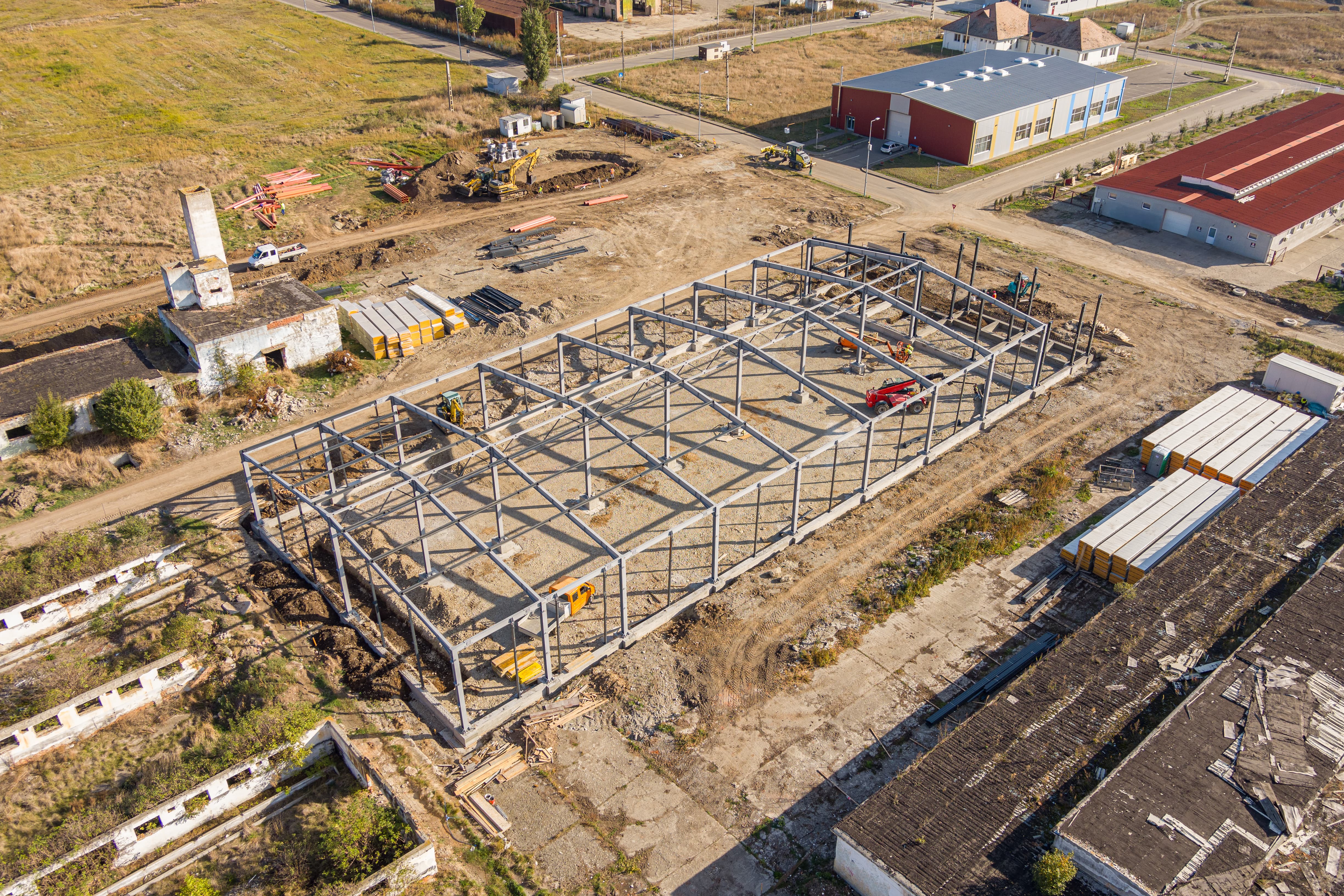 A close-up of a modern architectural staircase with curved railings and beige concrete, against a clear blue sky.