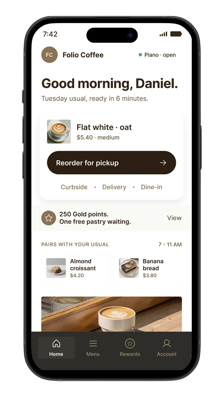 Mobile app screen greeting Daniel with coffee order summary: Flat white with oat milk, $5.40, medium, ready in 6 minutes, options for curbside, delivery or dine-in, shows 250 gold points and free pastry offer, almond croissant $4.20, banana bread $3.80, navigation bar with Home, Menu, Rewards, Account.