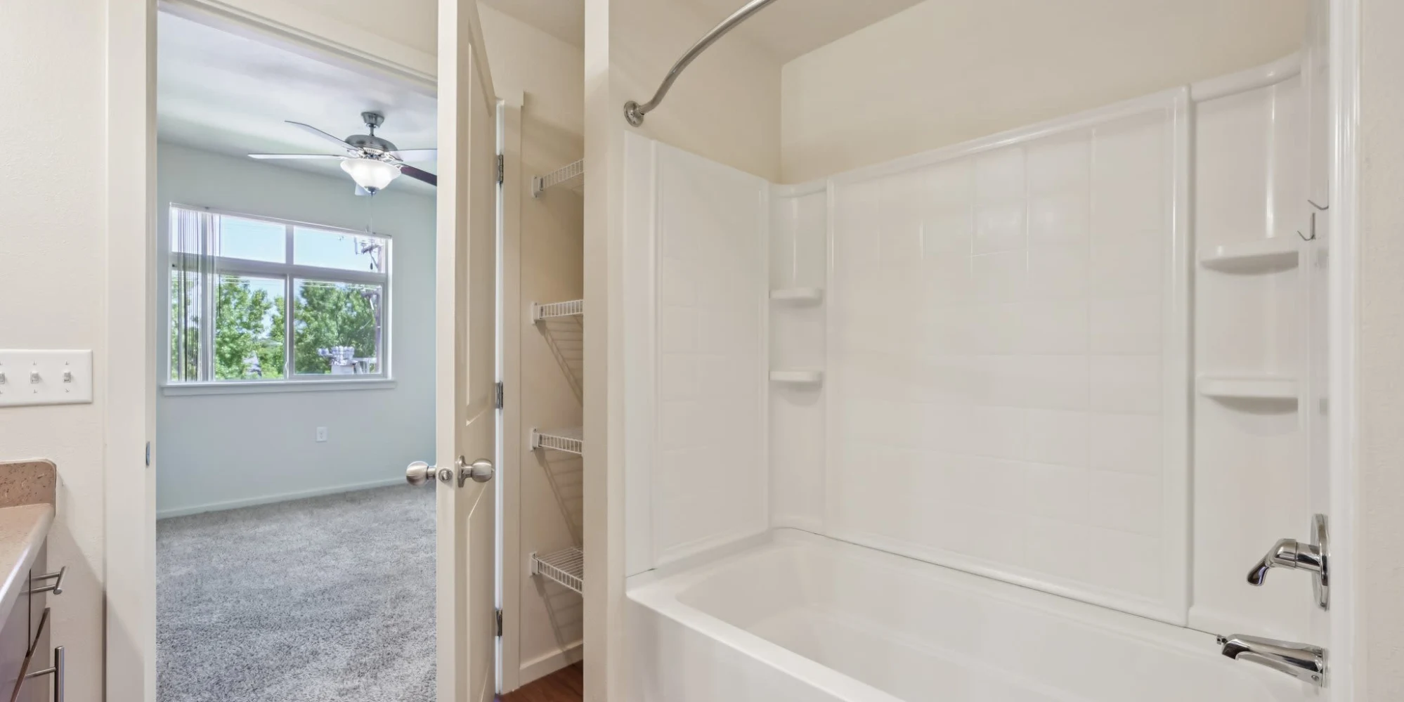 Bathroom with tub and bedroom view