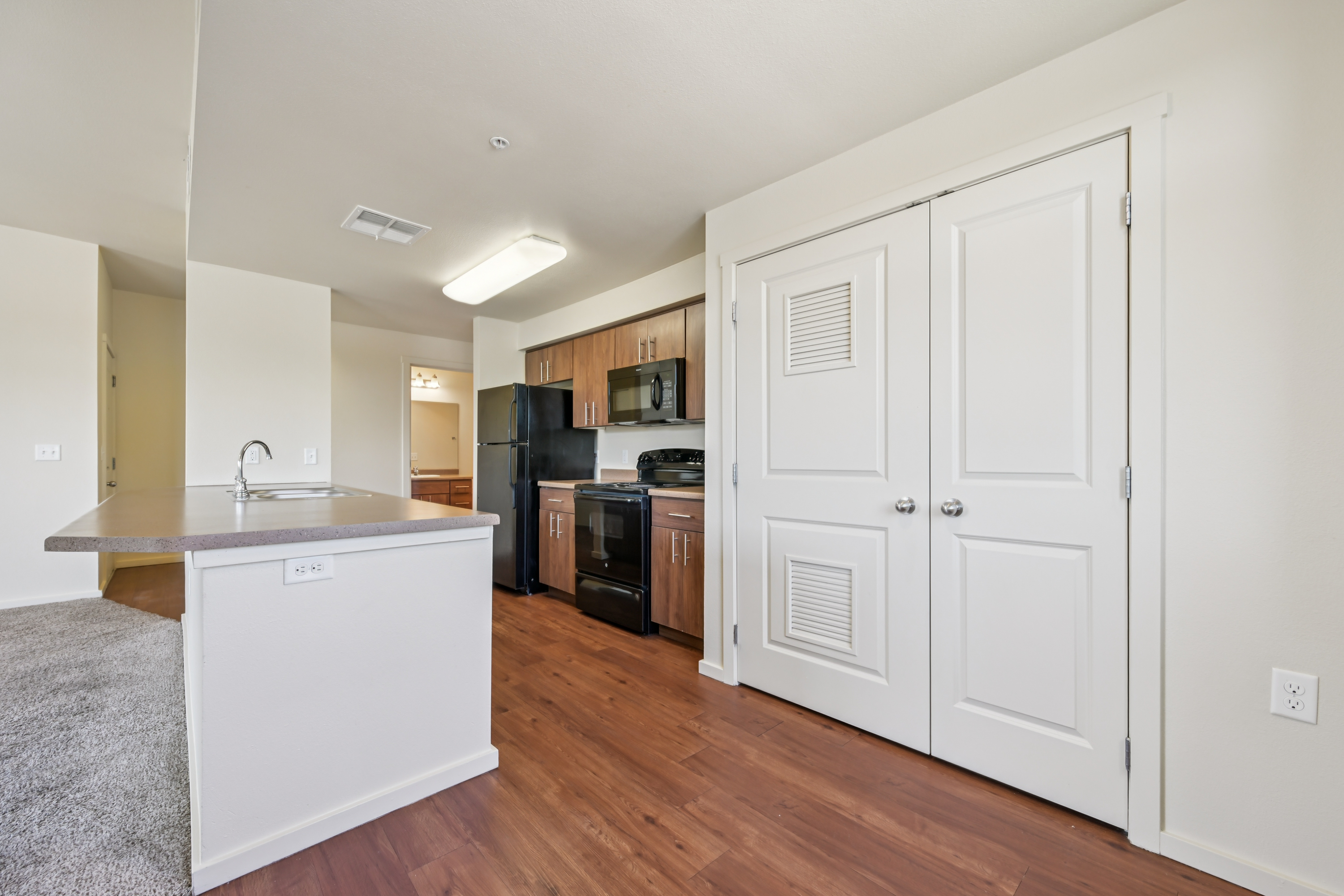 Open kitchen featuring oversized island, ample cabinet space, and modern finishes at Copper Creek Apartments