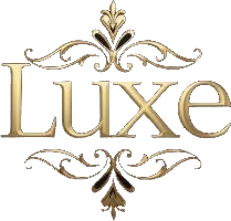 The word 'Luxe' in elegant gold script with decorative gold flourishes above and below it.