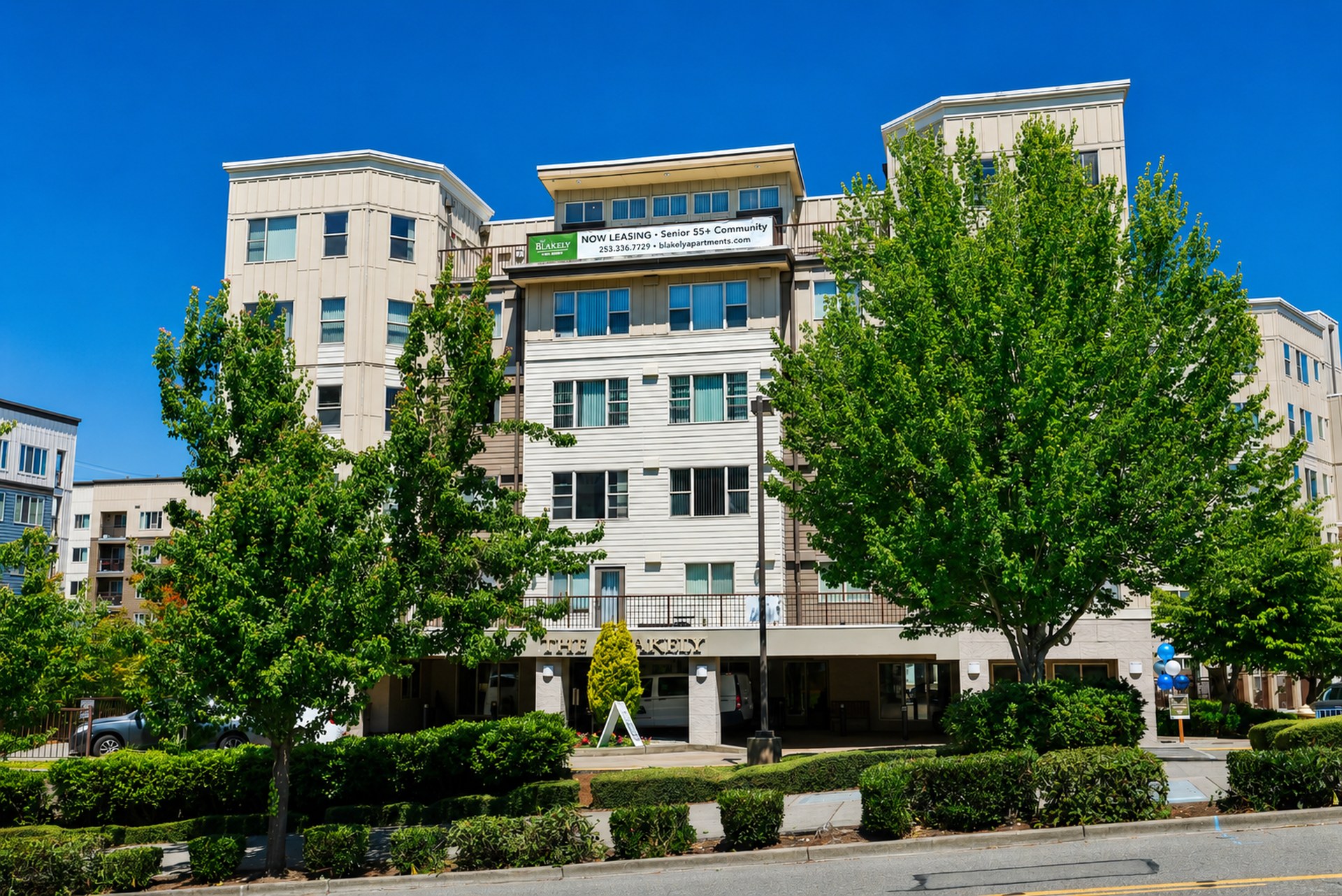 Exterior view of The Blakely building with multiple stories, windows, and underground parking below the building.
