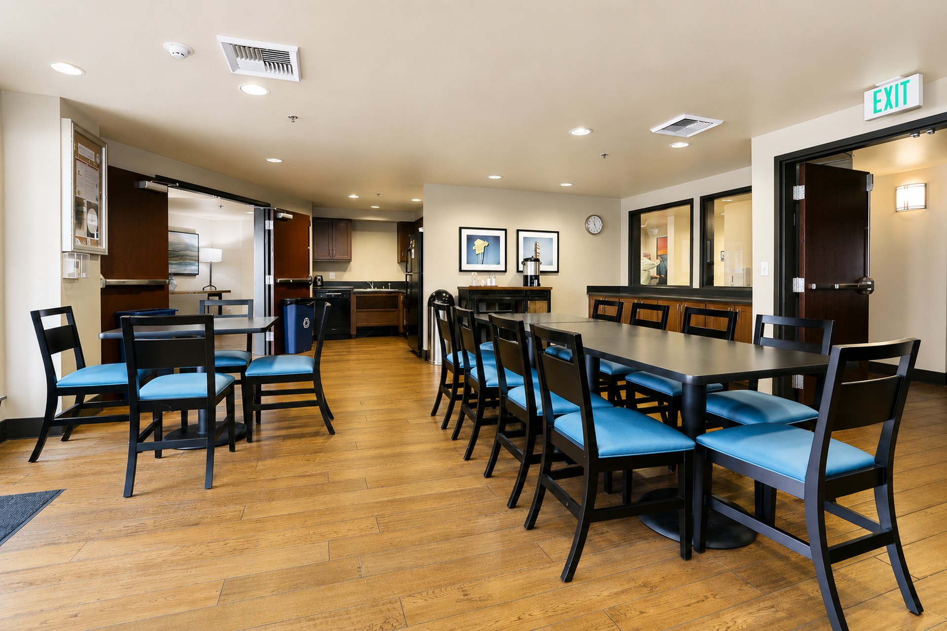 Café with kitchen, long gathering tables and plenty of seating