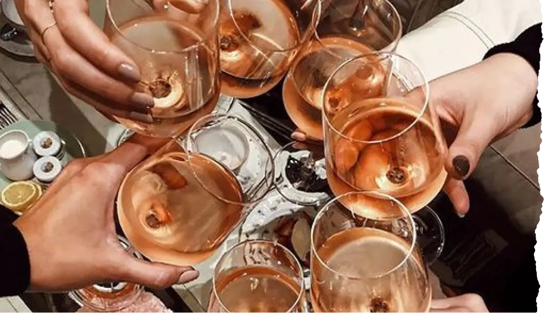 Hands toasting wine glasses