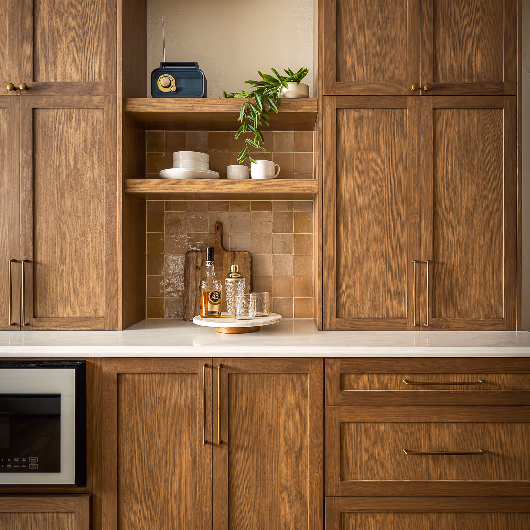 Kitchen with wooden cabinets, and white countertops.