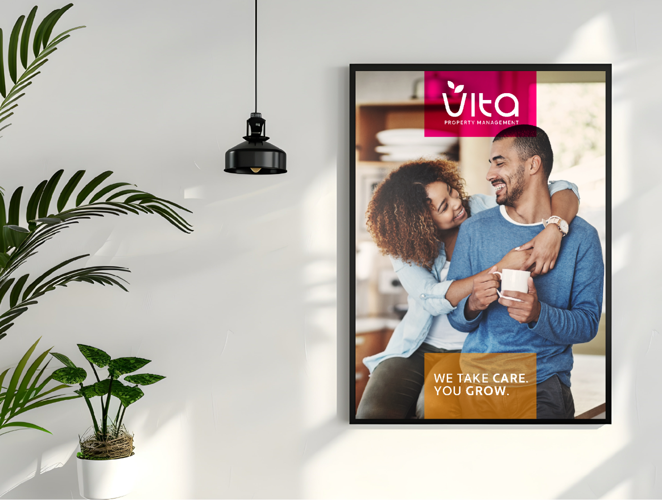 Framed poster on wall showing smiling couple embracing, with Vita Property Management logo and text 'We take care. You grow.'