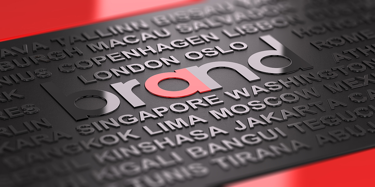 3D embossed black panel with city names and the word 'brand' highlighted in black, pink, and gray letters.