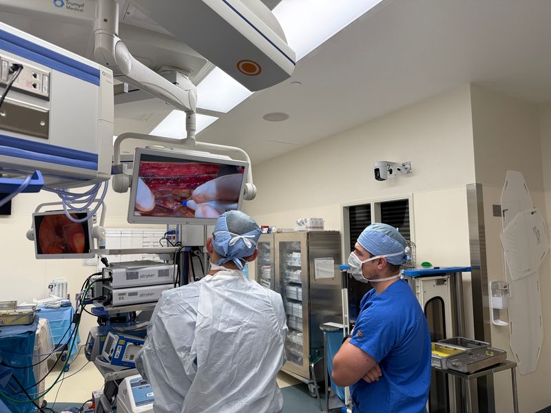 Live surgical video cast to an OR screen for the whole team