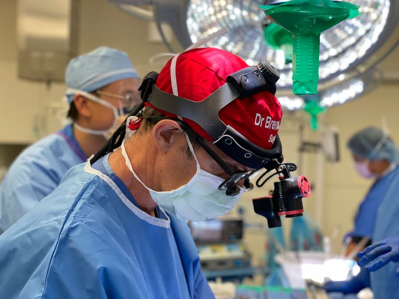Surgeon wearing CinVivo Titan 4K HDR head-mounted camera during a procedure
