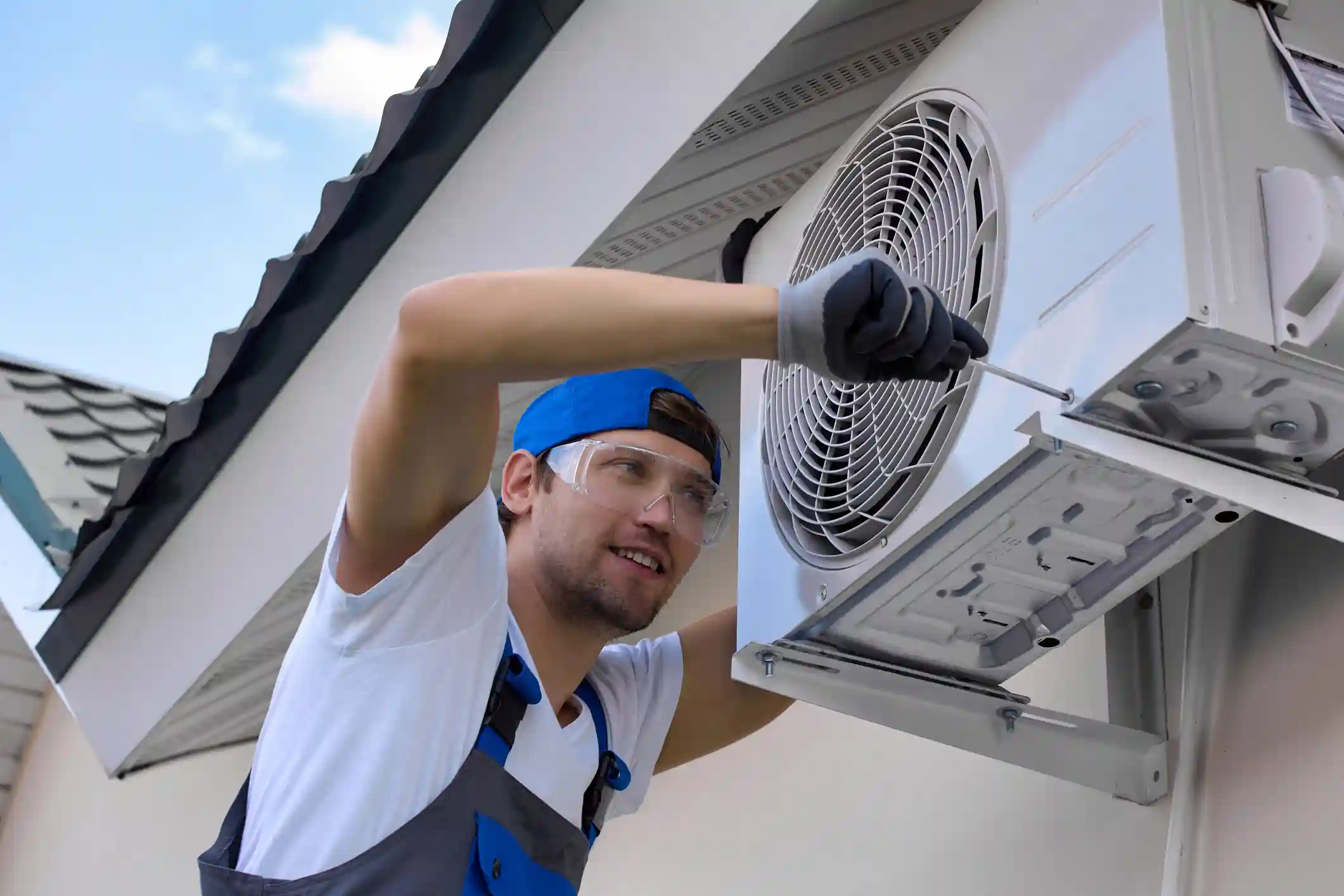 Technician installing outdoor air conditioning unit.