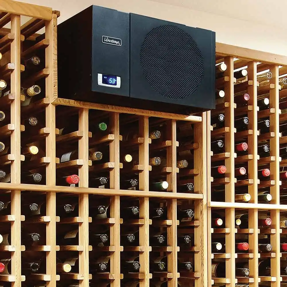 A black Vinotemp wine cellar cooling unit mounted on a wooden wine rack filled with bottles.