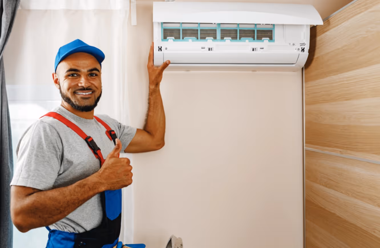 technician gesturing thumbs up indoors.