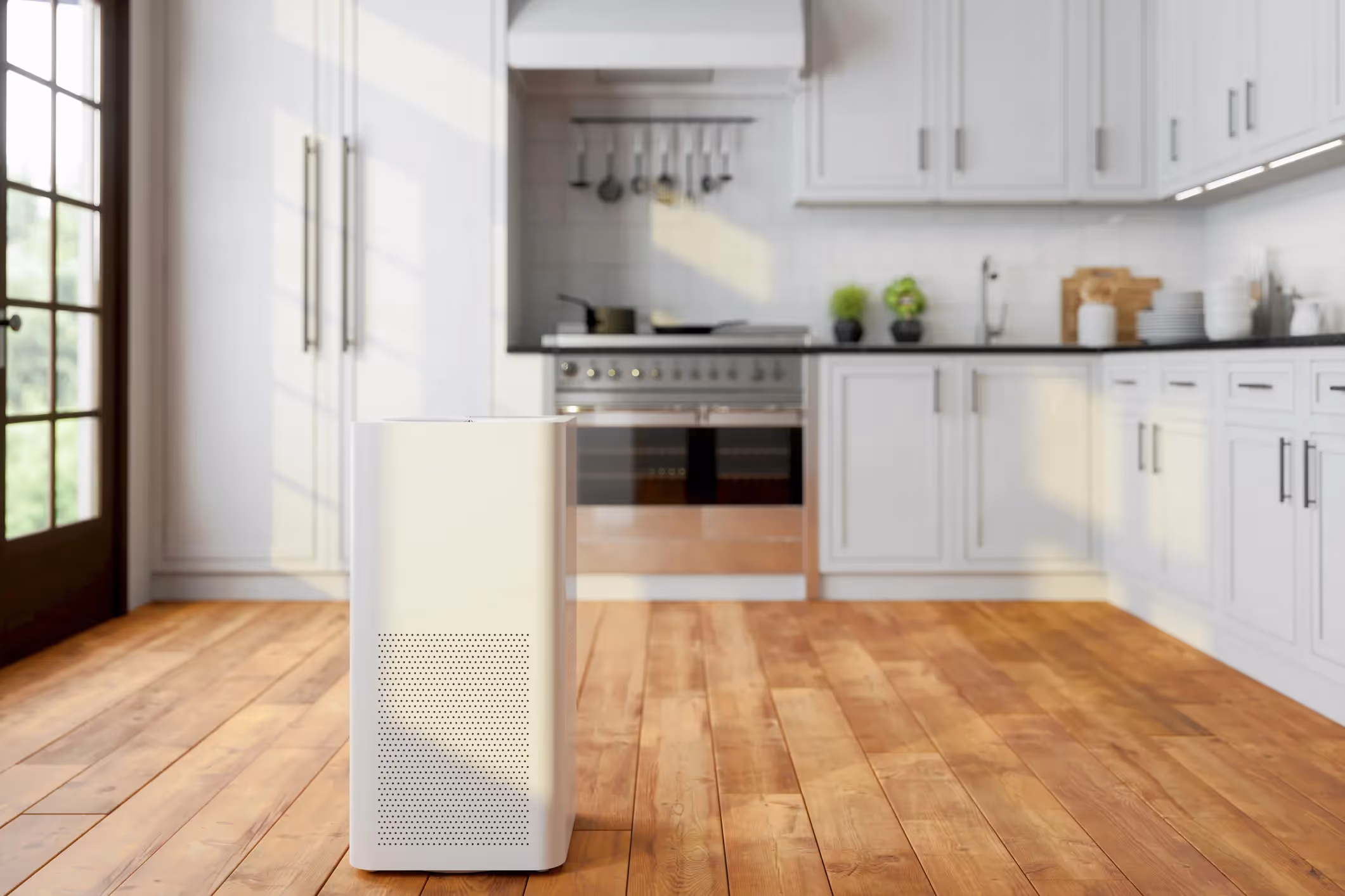 Large white air purifier standing on a wood floor in a brightly lit modern kitchen.