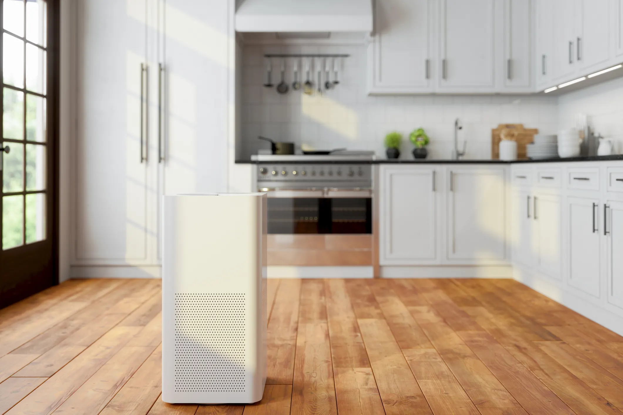 Large white air purifier standing on a wood floor in a brightly lit modern kitchen.