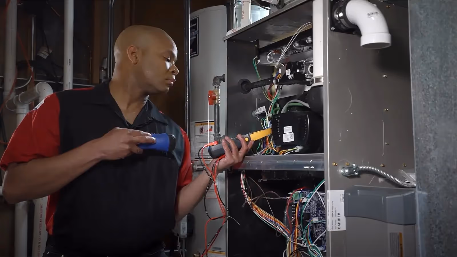 Technician testing HVAC unit electrical wiring.