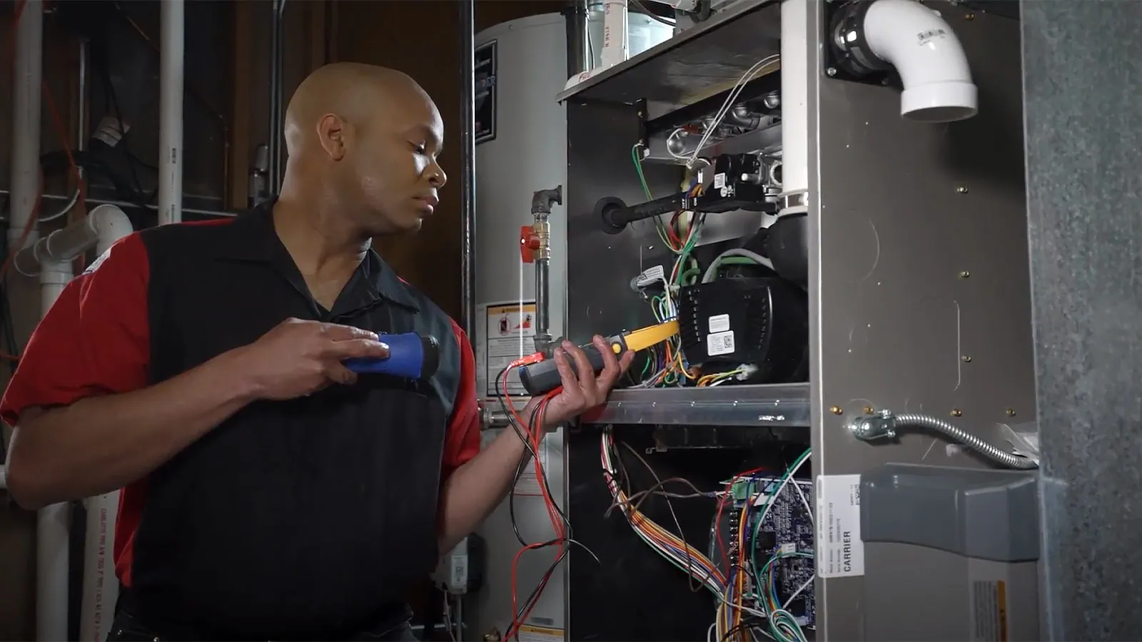 Technician testing HVAC unit electrical wiring.