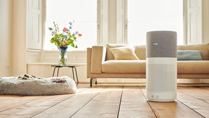 Modern air purifier in sunny living-room.
